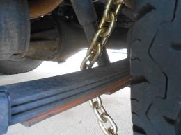 bolt cutter proof 10mm diameter high tensile chain wrapped around the leaf springs and wheel
